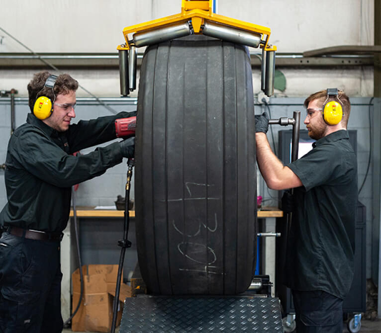 Kalitta Air Tire and Brake employees mounting a tire